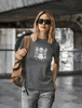 Woman wearing a soft, eco-friendly Horror Child T-Shirt with playful ghostly cartoon characters printed on the front